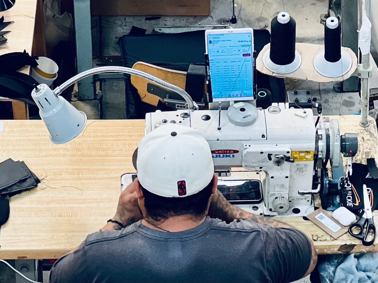 Worker using UpSew app at sewing station